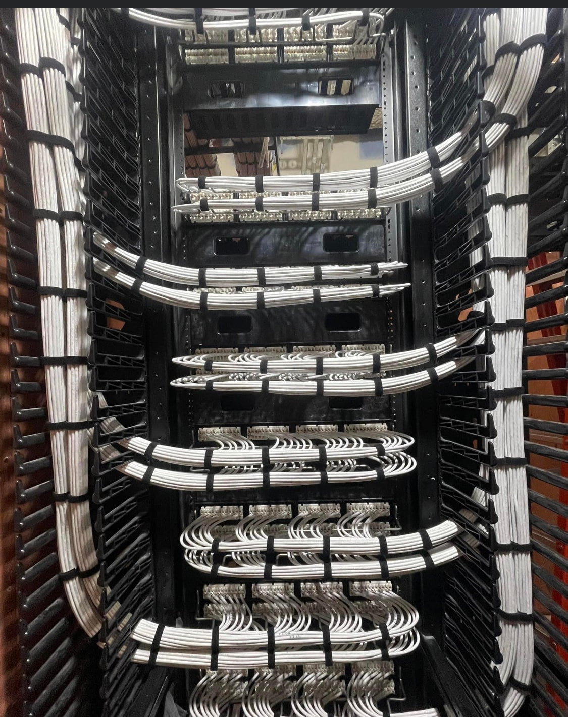 Professionally organized MDF rack with labeled patch panels